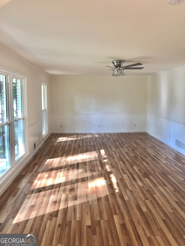 spare room featuring dark hardwood / wood-style floors and ceiling fan