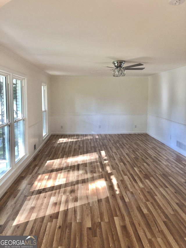 4330 Cedar Valley Ln, Conley, GA 30288 - unfurnished room with wood finished floors, a wainscoted wall, and ceiling fan