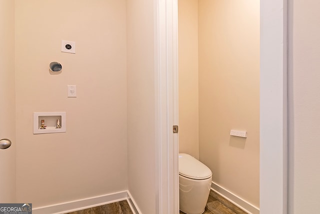 bathroom with hardwood / wood-style floors and toilet