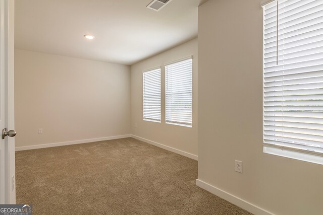 unfurnished room with light colored carpet