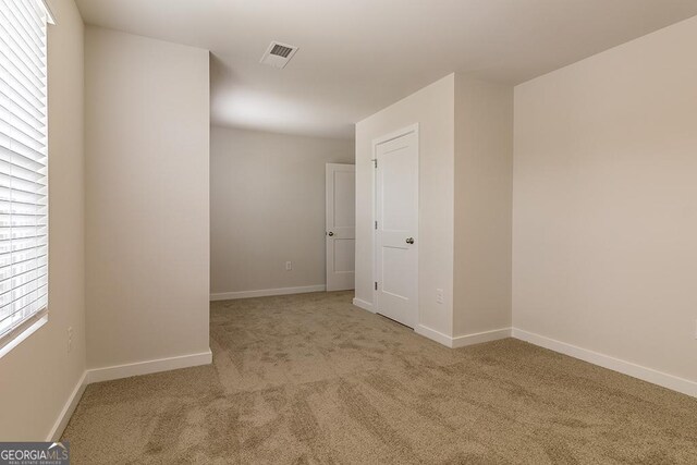 empty room with light colored carpet