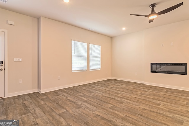 unfurnished room featuring ceiling fan and hardwood / wood-style floors