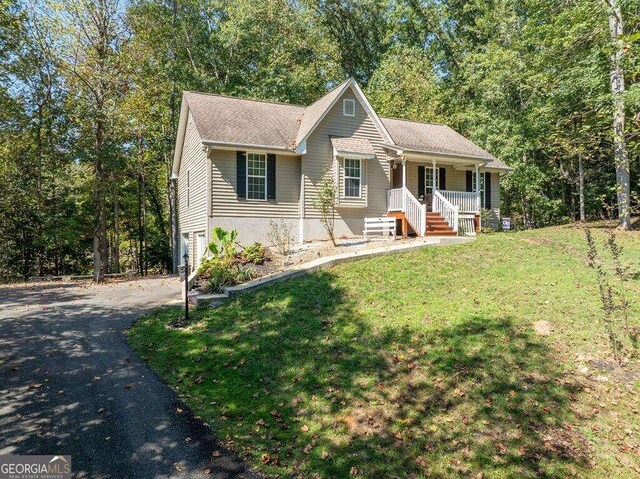 view of front of house with a porch and a front lawn