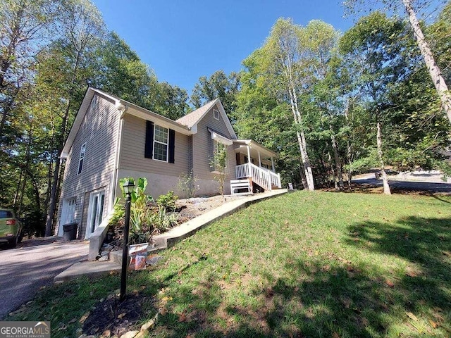 view of home's exterior with a garage and a yard