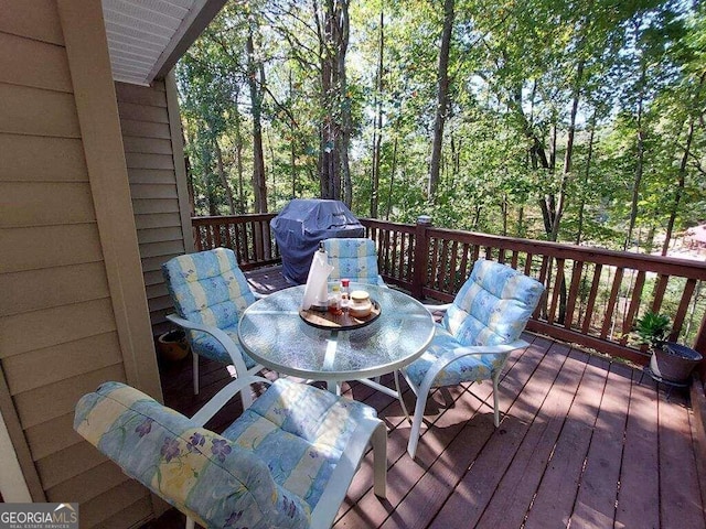 wooden deck with a grill