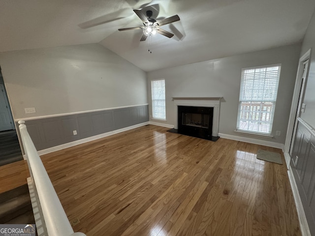 unfurnished living room featuring vaulted ceiling, ceiling fan, and hardwood / wood-style floors