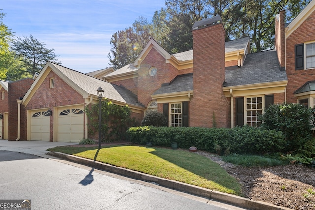 view of front facade with a garage and a front lawn