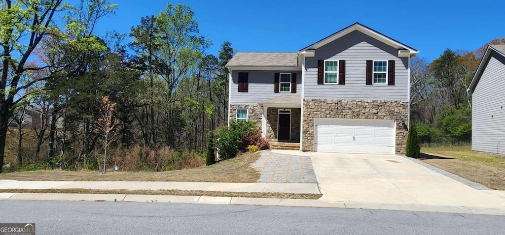 128 Embry Blvd, Pendergrass, GA 30567 - view of front of property featuring stone siding, concrete driveway, and a garage