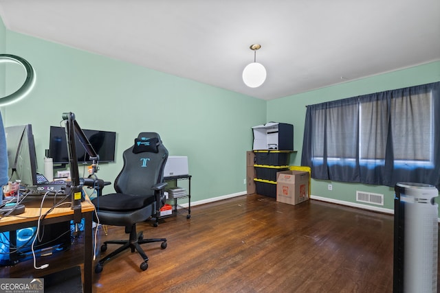 home office with dark hardwood / wood-style floors