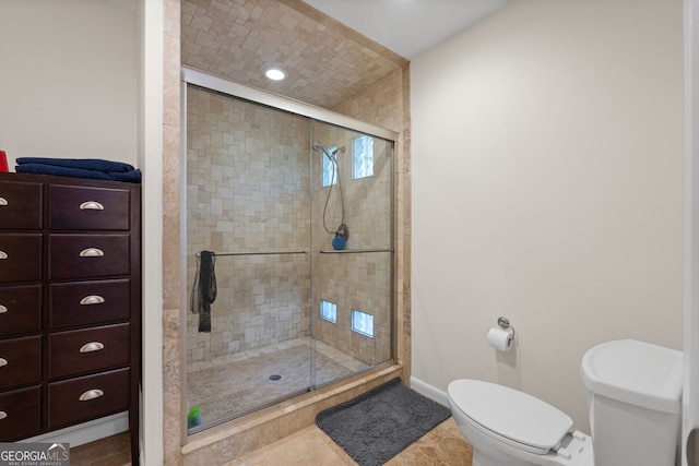 bathroom with walk in shower, tile patterned floors, and toilet