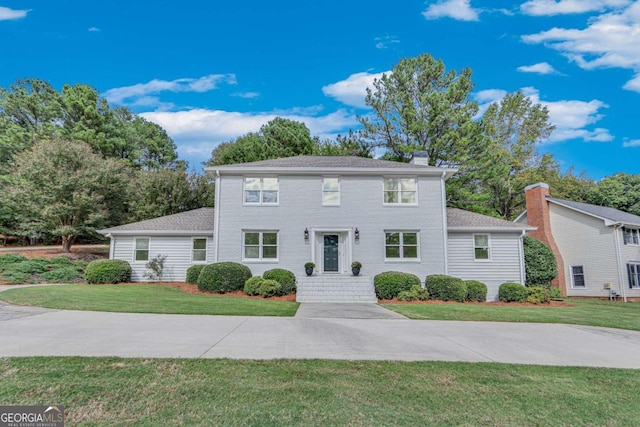 colonial home with a front yard