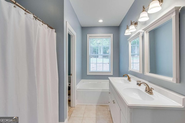 bathroom with vanity, a bathing tub, and tile patterned flooring