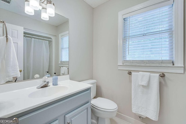 bathroom featuring vanity and toilet