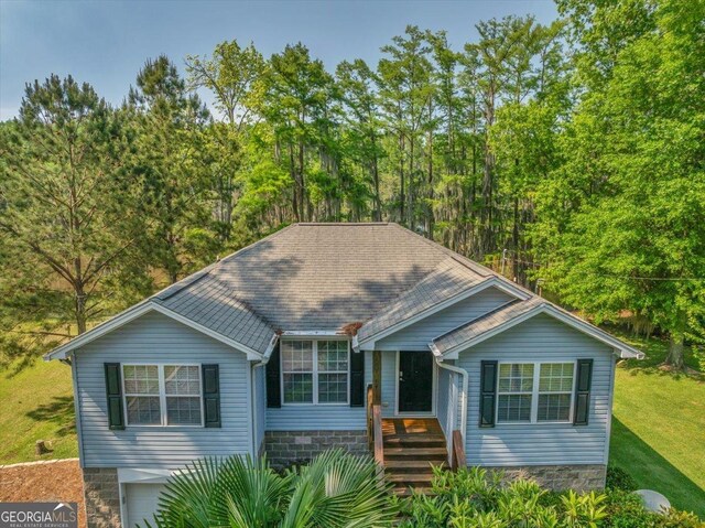 view of front of property with a front lawn and a garage