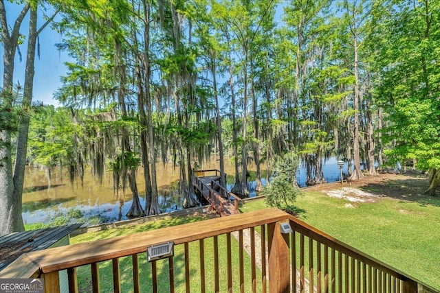 wooden terrace with a lawn and a water view
