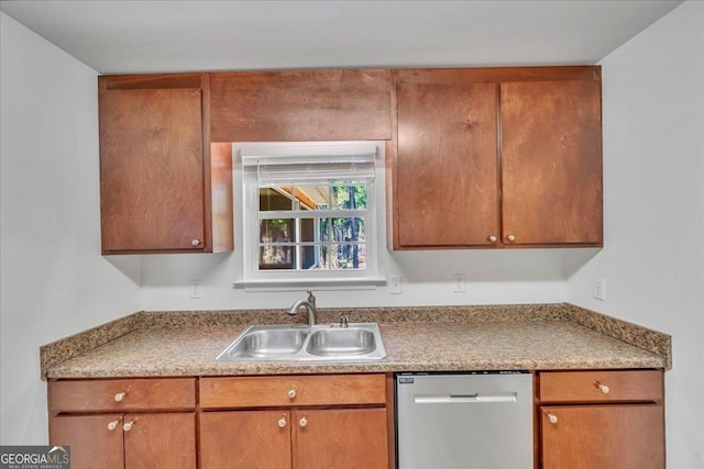 kitchen featuring brown cabinetry, stainless steel dishwasher, and a sink