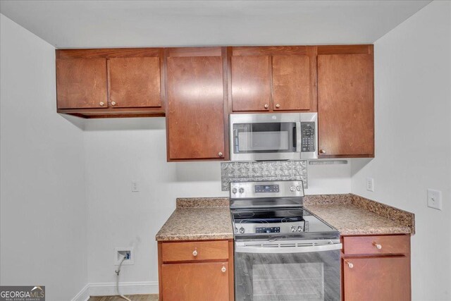 123 E Entreken Rd, Cobb, GA 31735 - kitchen featuring brown cabinetry, stainless steel dishwasher, and a sink