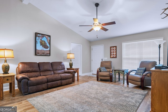 living room with ceiling fan, light wood-type flooring, and lofted ceiling