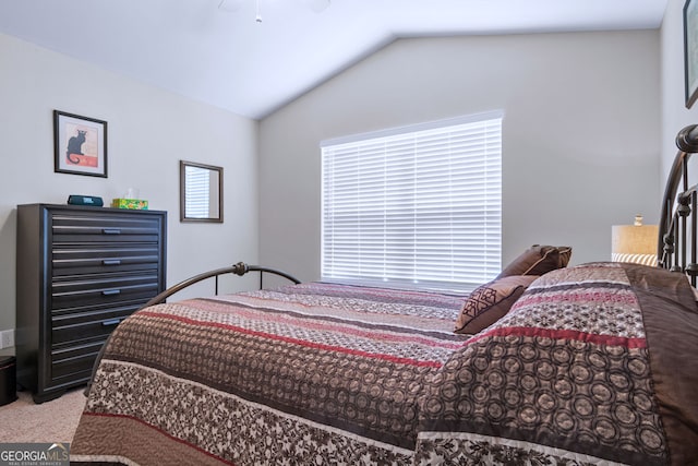 carpeted bedroom with vaulted ceiling and ceiling fan