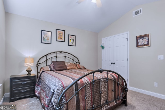 carpeted bedroom with lofted ceiling, a closet, and ceiling fan