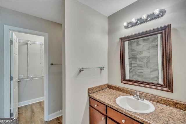 bathroom with wood finished floors and vanity