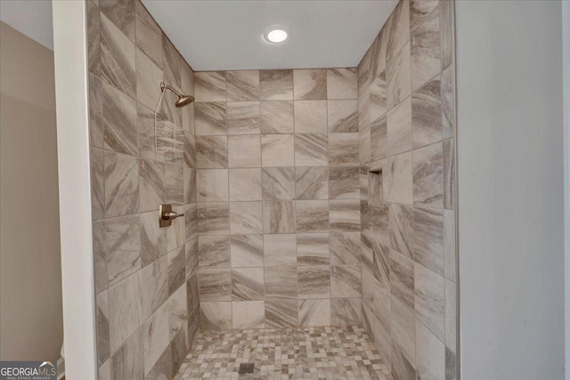 full bathroom with a tile shower
