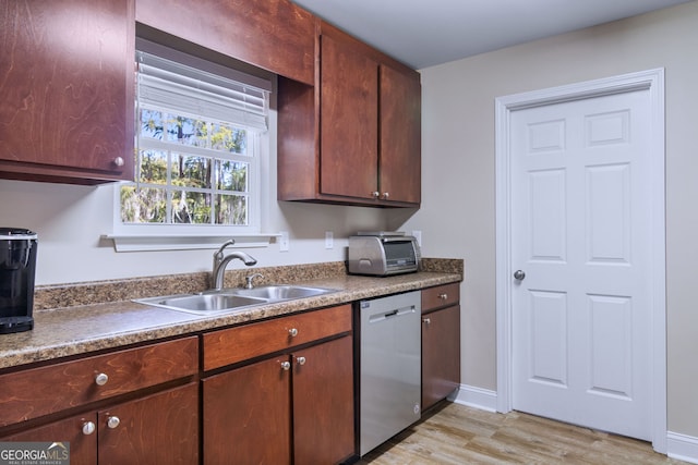 kitchen featuring light wood-type flooring, sink, and stainless steel dishwasher