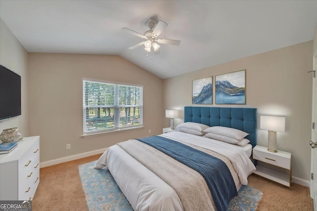 carpeted bedroom with lofted ceiling, baseboards, and ceiling fan