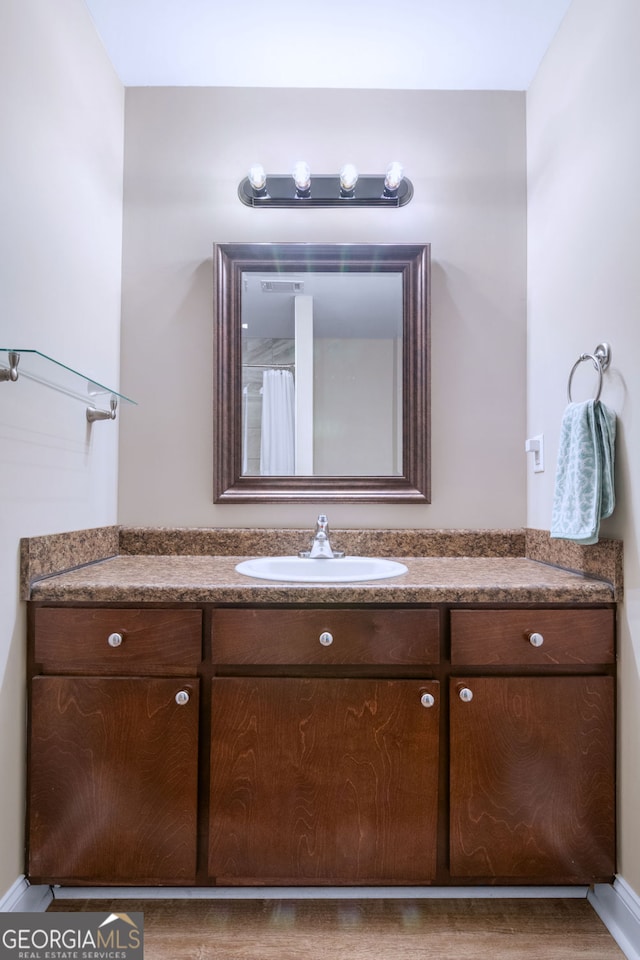 bathroom with hardwood / wood-style floors and vanity