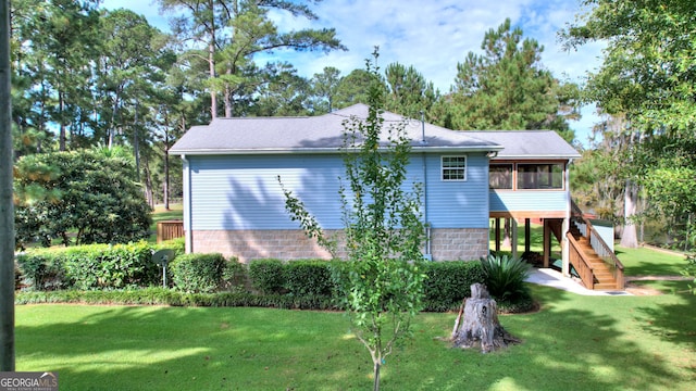 exterior space with a yard and a sunroom