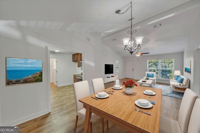 living area with light wood finished floors, vaulted ceiling, visible vents, and ceiling fan with notable chandelier