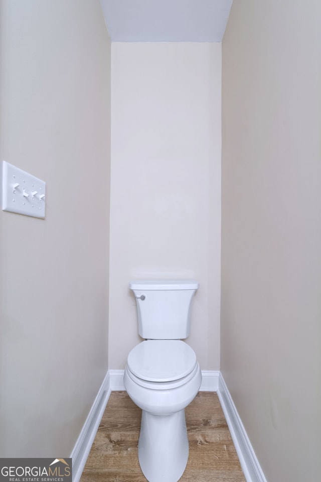 bathroom with wood-type flooring and toilet