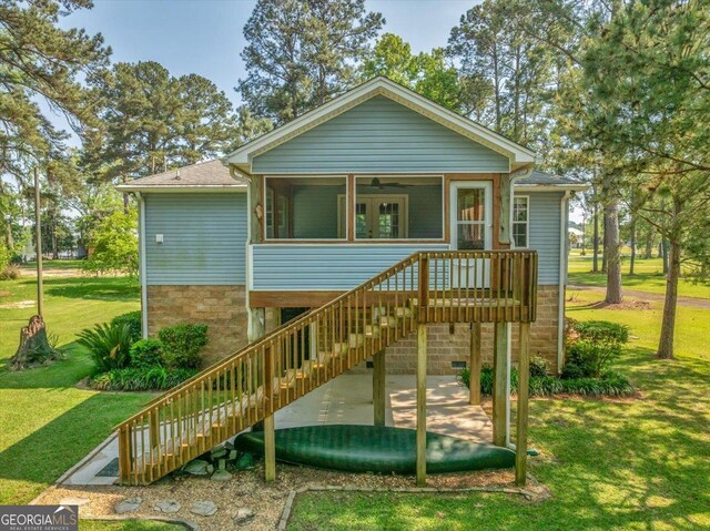 123 E Entreken Rd, Cobb, GA 31735 - view of playground featuring a lawn, an outdoor structure, a sunroom, and stairs