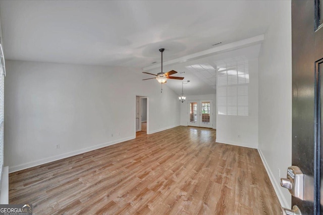 unfurnished living room with lofted ceiling with beams, baseboards, a ceiling fan, and light wood-style floors