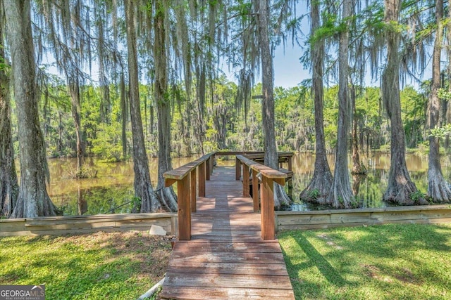 dock area featuring a forest view