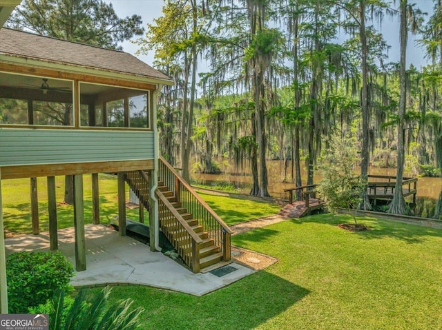 view of jungle gym with a yard, a patio area, a sunroom, and stairs