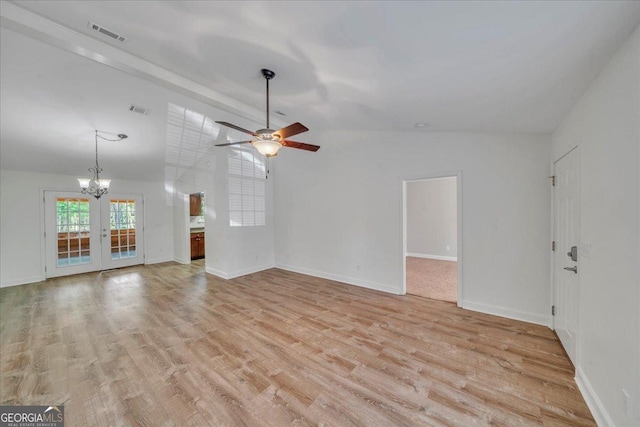 unfurnished living room featuring vaulted ceiling, visible vents, light wood-style flooring, and french doors