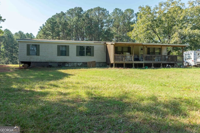 back of property featuring a lawn