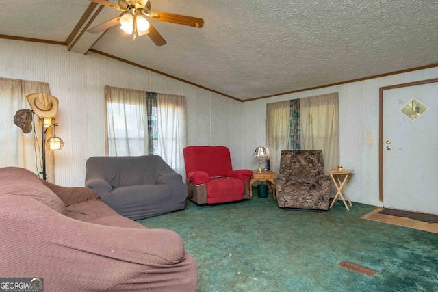 carpeted living room with ornamental molding, lofted ceiling with beams, a textured ceiling, and ceiling fan