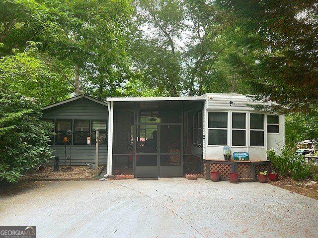 view of outbuilding featuring a sunroom