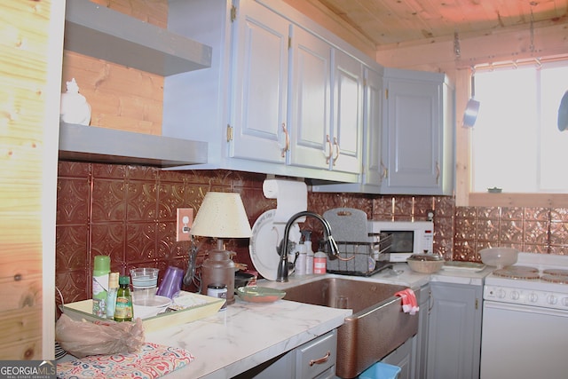 kitchen featuring sink, decorative backsplash, range, and wood ceiling