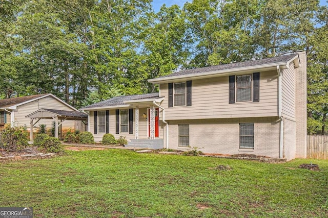split level home with a front yard and brick siding