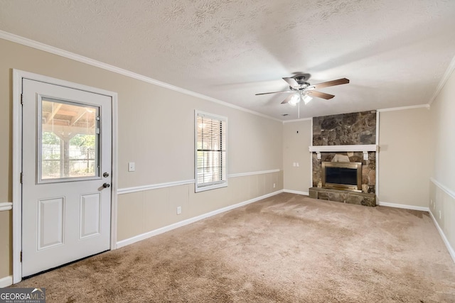 unfurnished living room featuring ornamental molding, carpet floors, a ceiling fan, and a textured ceiling