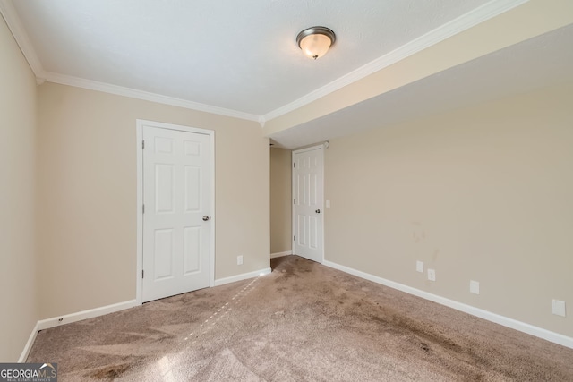 spare room featuring crown molding and light colored carpet