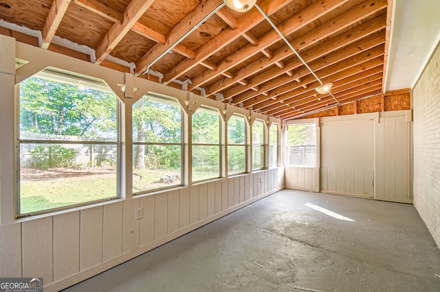 unfurnished sunroom featuring lofted ceiling