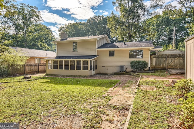 back of house featuring central AC, a yard, a sunroom, and a patio area