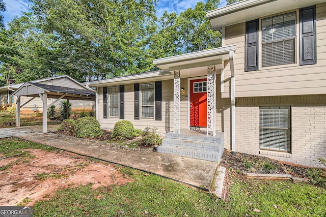 view of exterior entry featuring brick siding