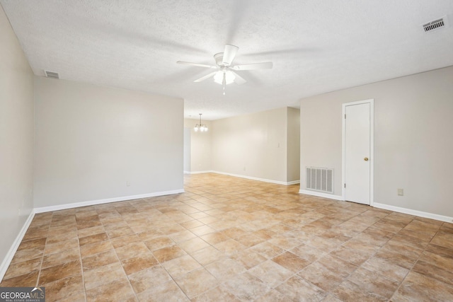 unfurnished room with visible vents, baseboards, and ceiling fan with notable chandelier