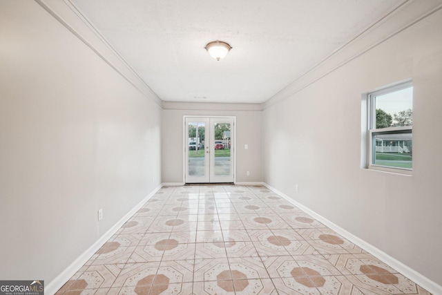 empty room with light tile patterned floors, baseboards, crown molding, and french doors