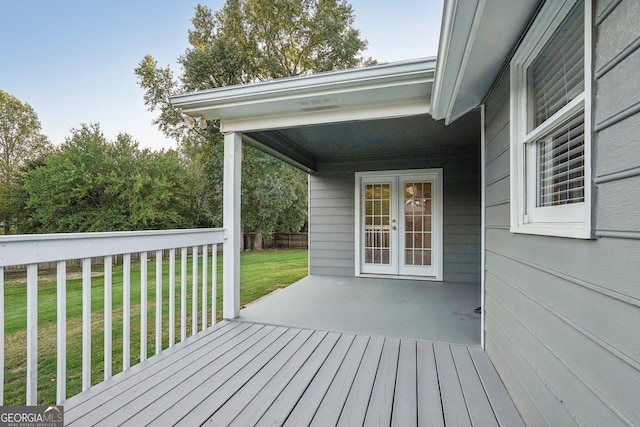 wooden deck featuring a yard and fence